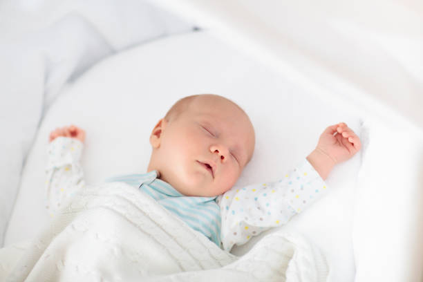 istock Cute newborn baby in white bed 2191210866