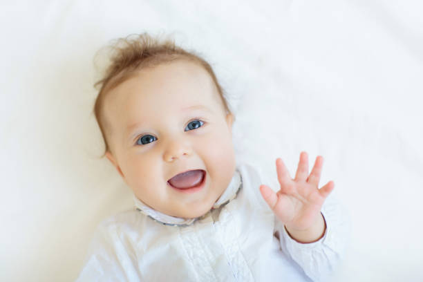 istock Little baby on white bed 2191210958