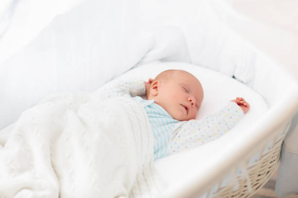 istock Cute newborn baby in white bed 2191211047