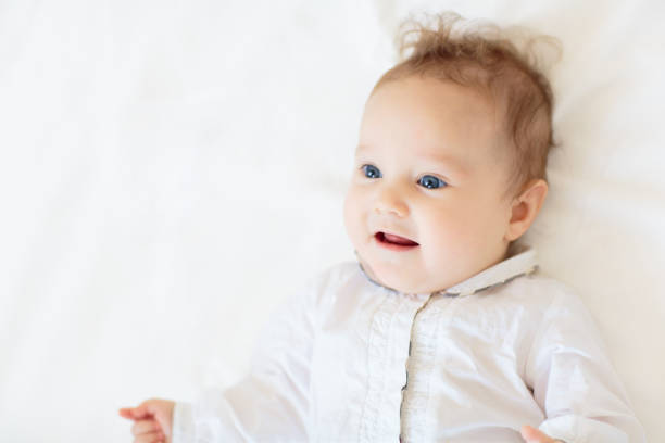 istock Little baby on white bed 2191211470