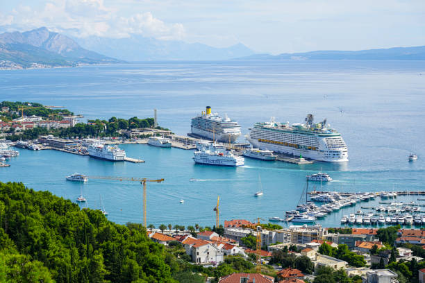 Split, Croatia - September 20, 2024: Beautiful aerial view of Split harbor with cruise ships and passenger ferries, Adriatic and mountains background