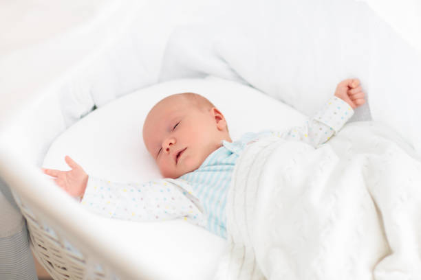 istock Cute newborn baby in white bed 2191212244