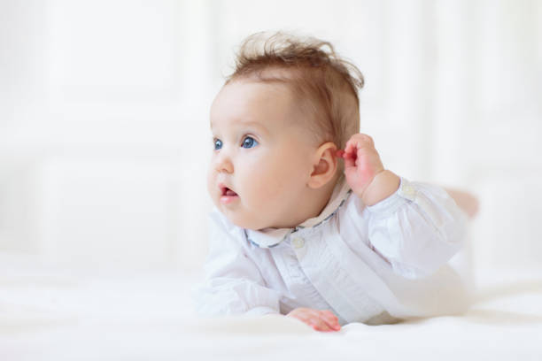 istock Little baby on white bed 2191212258