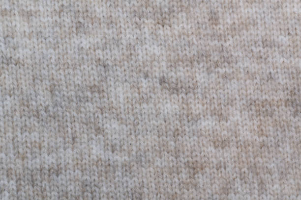 istock Beige wool knit: The soft texture of beige wool with a visible knit pattern of neat loops. 2191212991