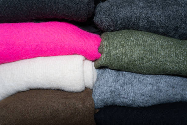 istock Soft and cozy textures of woolen fabrics are arranged in a stack, combining pink, green, beige, brown, and gray colors. 2191213001
