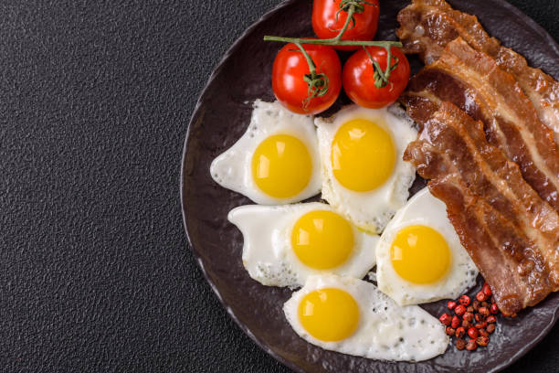 istock A hearty, delicious breakfast with fried eggs, bacon and tomatoes 2191213148