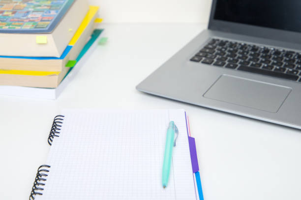 istock Notebook with pen and laptop on the desk. Education concept. 2191215154