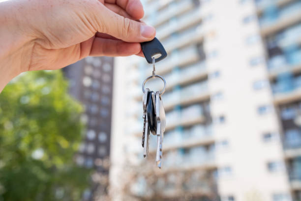 istock A person holds keys in front of a building that is currently under construction 2191221695