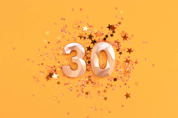 istock Golden number 30 and glowing stars confetti. 2191226181