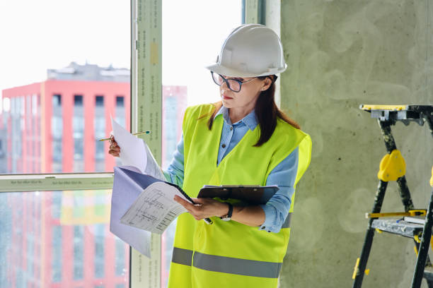 istock Technical profession woman in protective vest helmet working on construction 2191230479