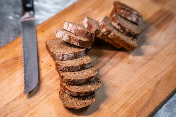 istock Sliced bread on a wooden cutting board 2191235255