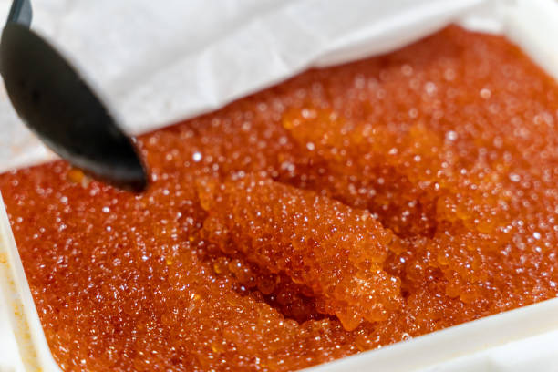A spoonful of red salmon caviar, sale of red chum salmon caviar