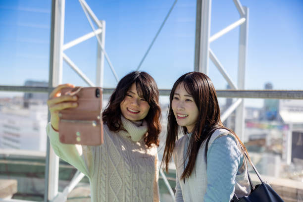 istock Female friends taking selfie picture on rooftop 2191247252