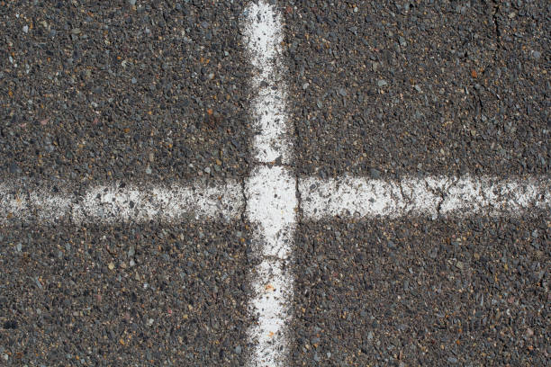 istock White cross lines painted on an asphalt bitumen concrete surface 2191251093