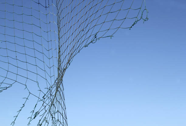 istock Damaged net against a clear blue sky abstract background 2191251174
