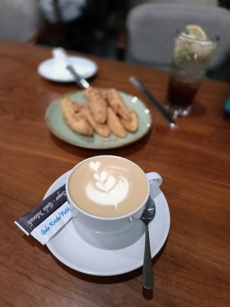 istock Coffee cup with latte art and cookies 2191251405