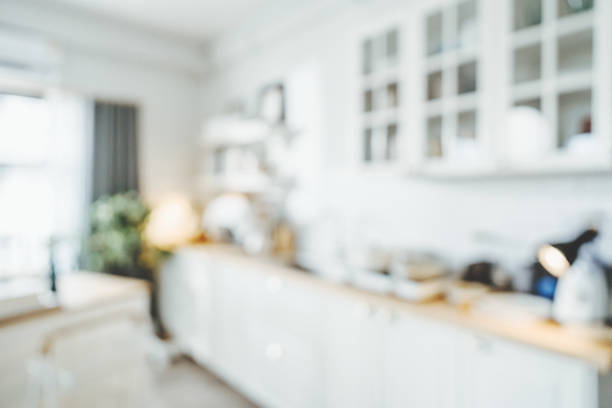 Blurred background modern kitchen and dinning room in house with bokeh light