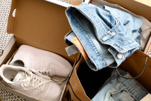 istock White sneakers and jeans in paper bags 2191252207