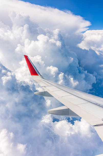 istock View from the airplane window at a beautiful cloudy sky and the airplane wing 2191255820
