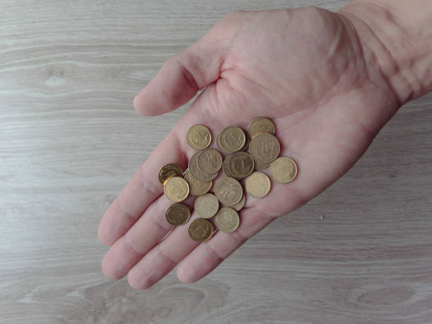 istock A hand is holding a pile of coins 2191257845