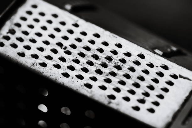 A grater sits atop a metal grater.