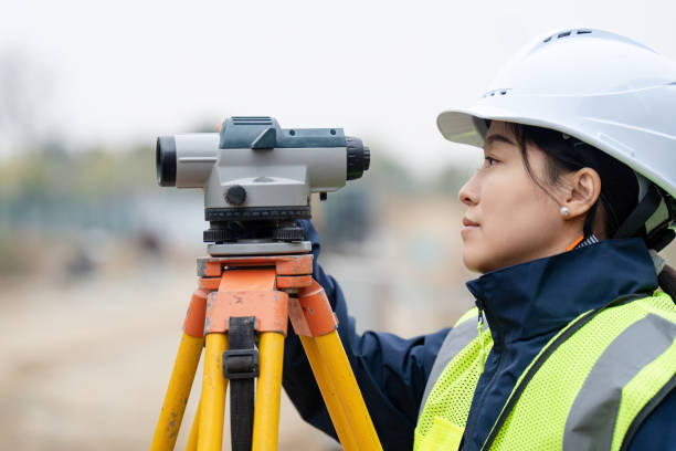 istock Engineer is using a survey camera to measure levels on a construction site 2191263135