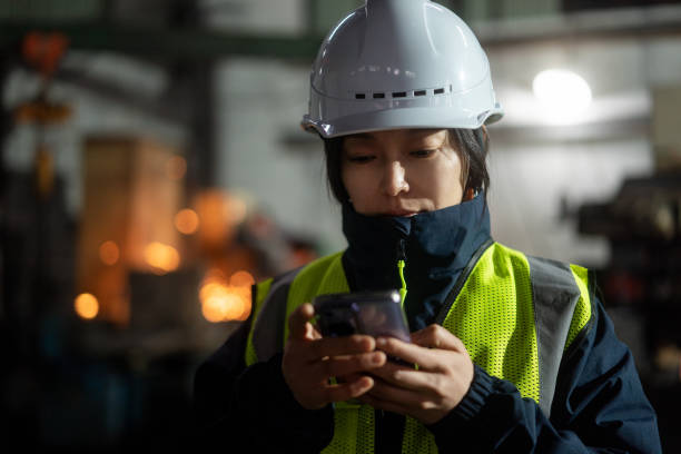 istock asian female engineer working in factory with smart  phone 2191264253