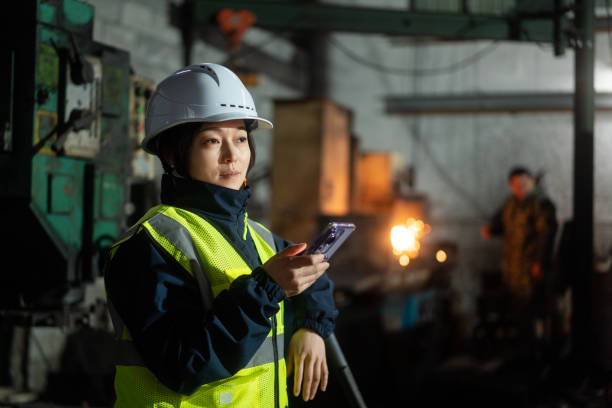 istock asian female engineer working in factory with smart  phone 2191264257