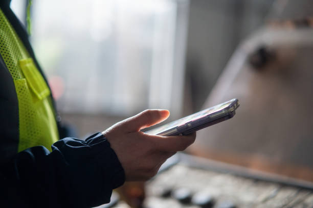istock asian female engineer working in factory with smart  phone 2191264341