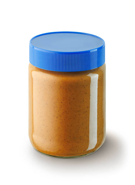 peanut butter in glass jar isolated on white background