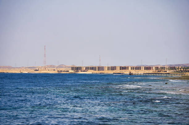 The Red Sea coastline with the sea visible, with beach umbrellas and typical Egyptian buildings