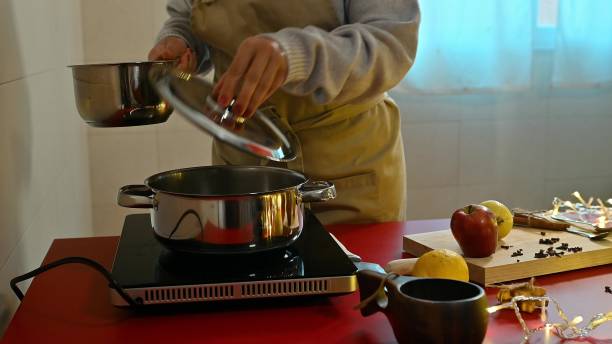 istock Person preparing mulled wine in a kitchen with fruits and spices 2191271589