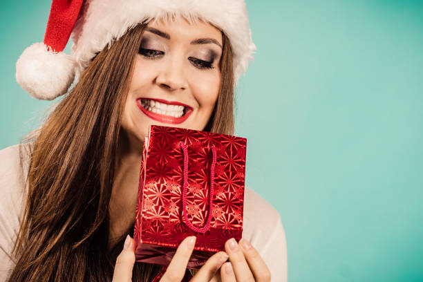 istock Happy Christmas woman holds red gift bag 2191271938