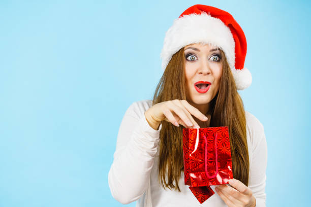 istock Excited christmas woman holds gift bag 2191272483