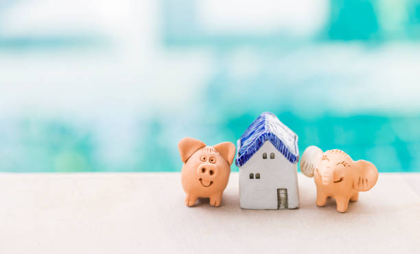 istock Pig and elephant clay sculpture with miniature house over blurred background 2191272681