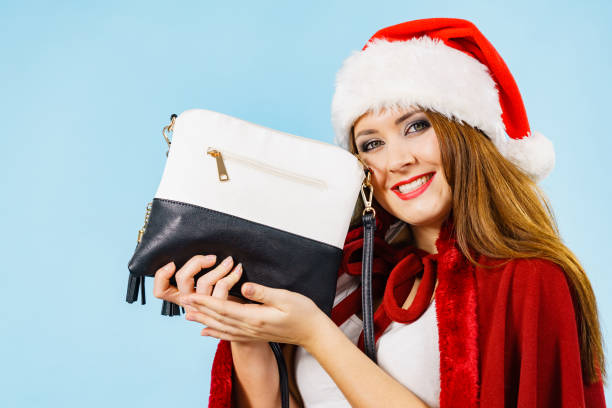 istock Christmas happy girl holding handbag present 2191272810