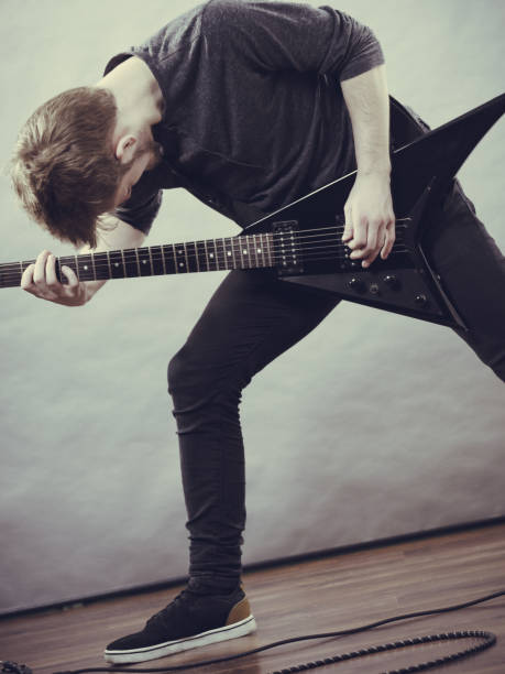 Musician carrying guitar on shoulder