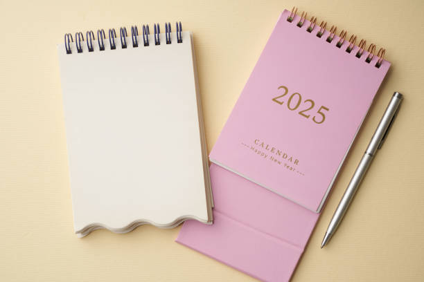 istock 2025 desk calendar and blank note pad for copy space 2191277854