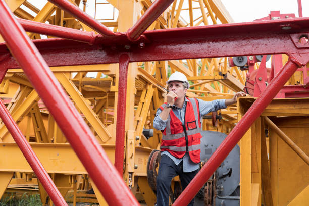 istock Professional male engineer construction with walkie talkie at crane construction site 2191278457