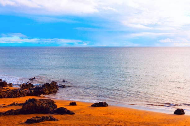istock Serene coastal scene with sandy beach and rocky formations 2191279108