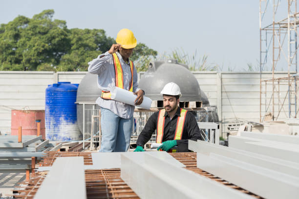 istock Male and female construction engineer worker working with blueprint and discuss together at construction site 2191280648