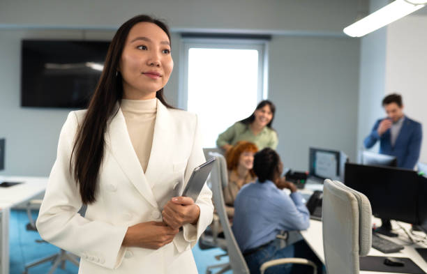istock Smiling businesswoman standing confidently in modern office space 2191280711