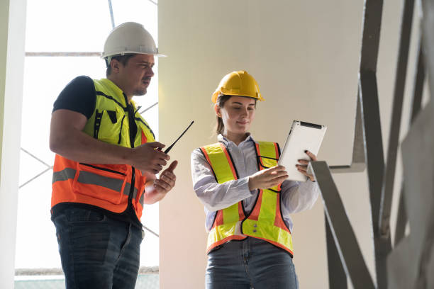 istock Male and female construction engineer worker working with digital tablet and discuss together at construction site 2191280921