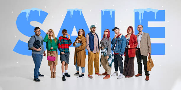 istock Group of shoppers dressed in trendy outfits standing confidently against backdrop with bold SALE text and icy winter accents. 2191281515