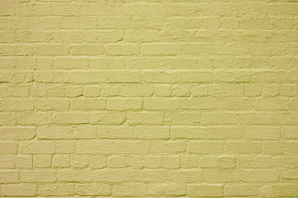 istock The brick wall is painted with yellow paint. 2191284233