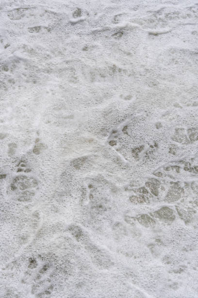 istock Sea foam, splashes of a large wave on the coast. 2191284697