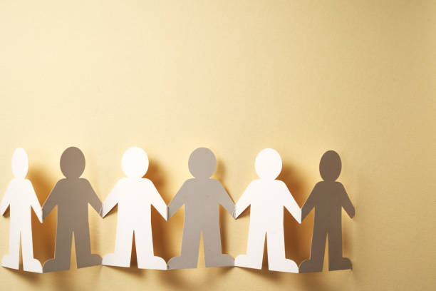 istock Cutted paper people holding hands for teamwork concept. 2191285320