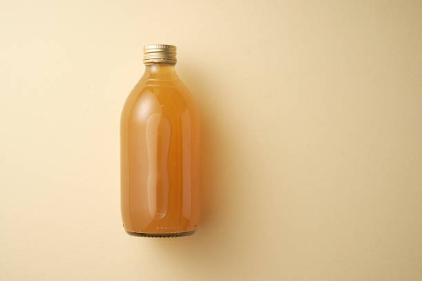 istock bottle of apple cider vinegar against yellow background 2191285736