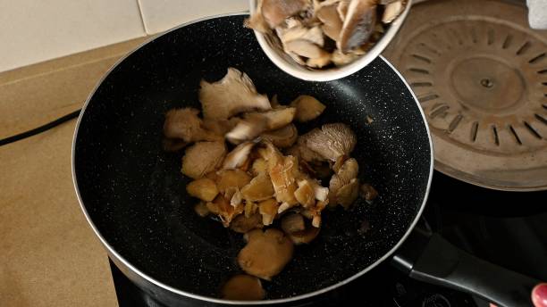 istock Adding Fresh Mushrooms to a Pan for a Delicious Vegetarian Paella 2191287940