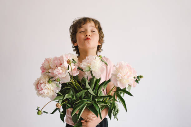 istock Cheerful happy child with Peonys bouquet. 2191288233